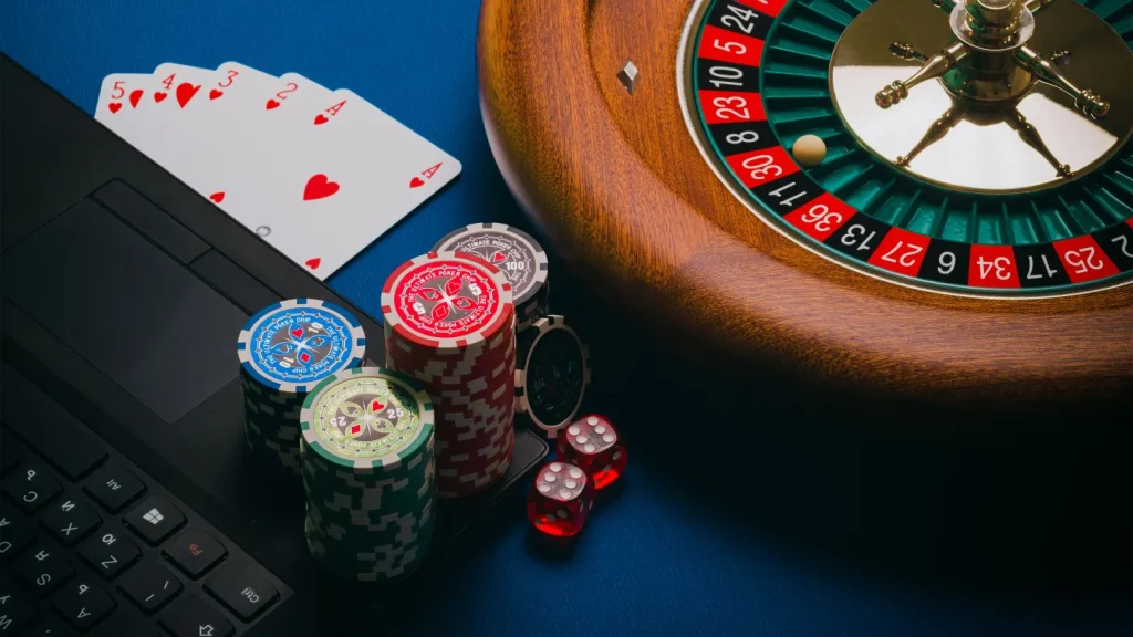 Roulette wheel, playing cards and chips used to compare casino game formats